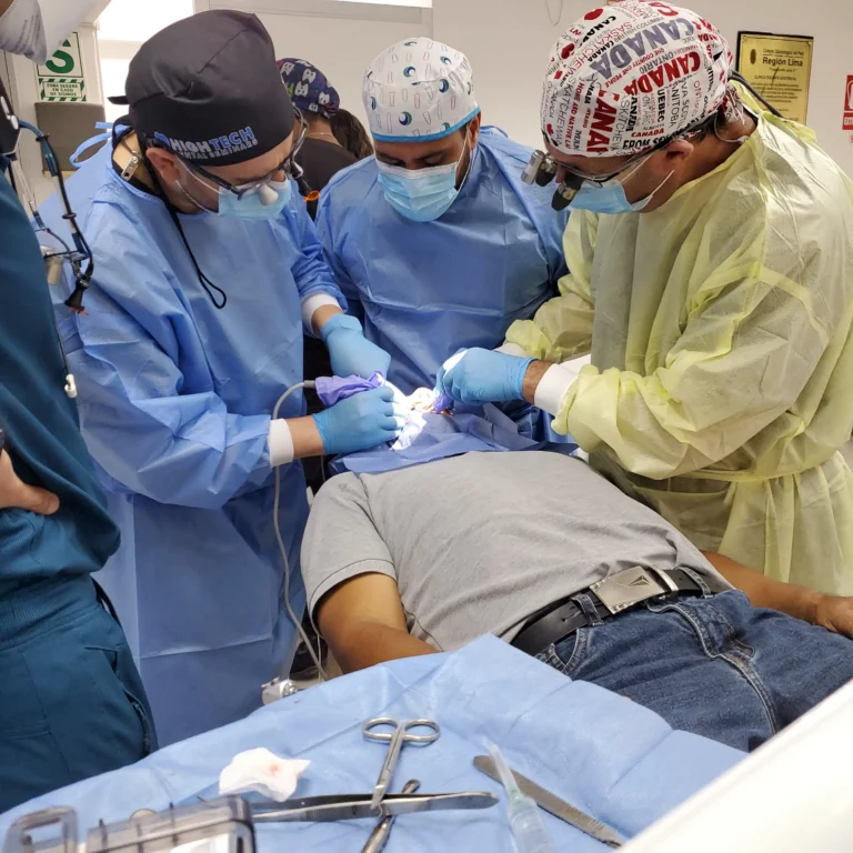Team of dental professionals collaborating during an All-on-X implant surgery, with surgical instruments laid out on a tray